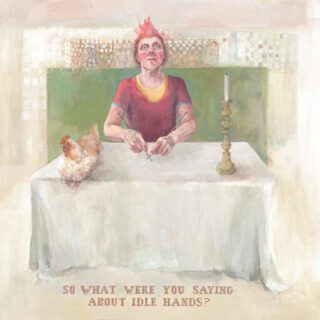 Figure in red with a headdress on sits at a cloth covered table on top of which is a hen and a candlestick