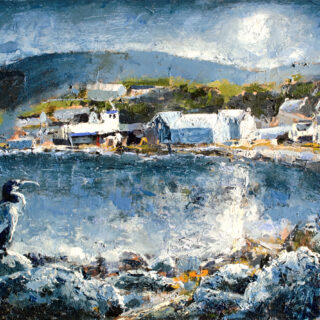 Coastal scene with water and rocks and buildings in the distance