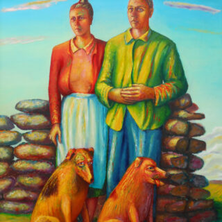 couple with two dogs next to a stone wall