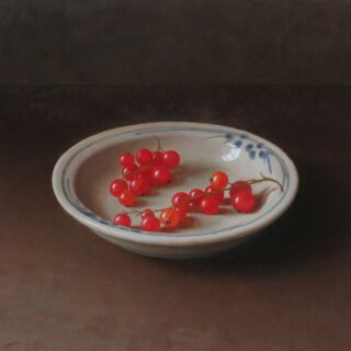 still life of red currants on a blue and white dish