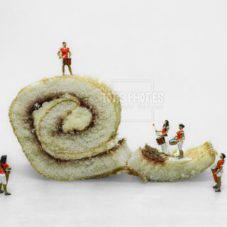 figurines with drums on a slice of swiss roll