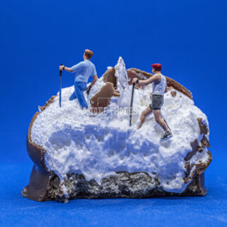 two figurines walking on the mallow of a teacake